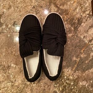 New black slip-on shoes with bow detail